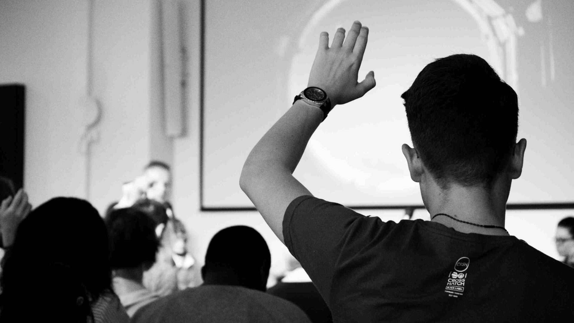 Man raising his hand in an meeting