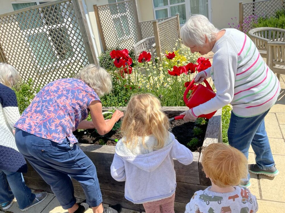 Care residents taking part in garden activities during care home open week