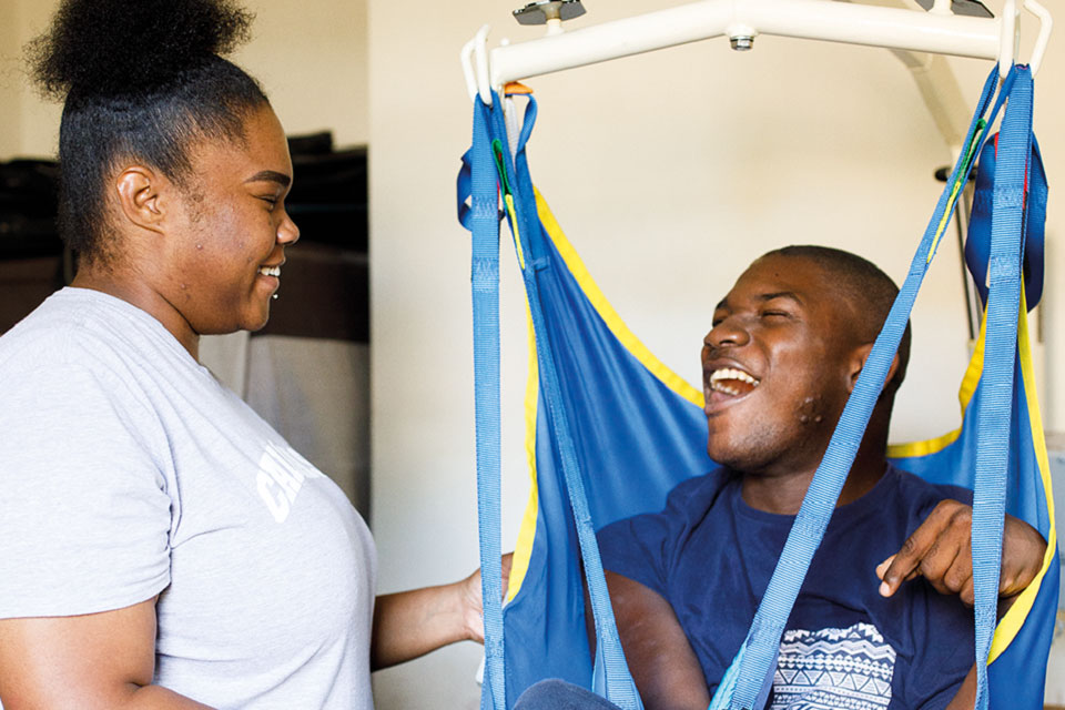 Carer and care resident laughing together